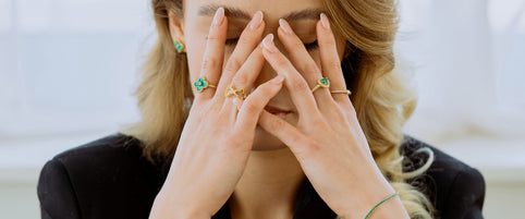 Loretana model hands covering face showing variety of authentic 925 sterling silver rings, real silver vs costume jewelry comparison. Kaunas.