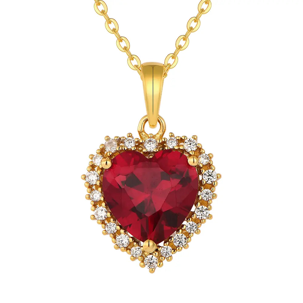 Close up of the 14K Gold Ruby Heart Necklace highlighting the precision-cut AAAAA ruby red zirconia and the polished 14K gold-plated setting.