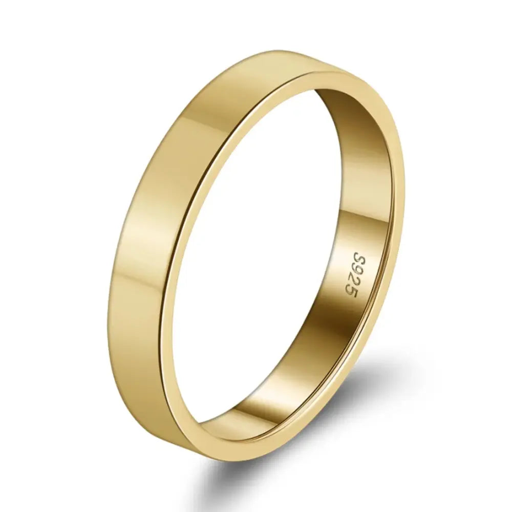 Close-up of the thin gold stacking ring highlighting the polished 3mm engravable band