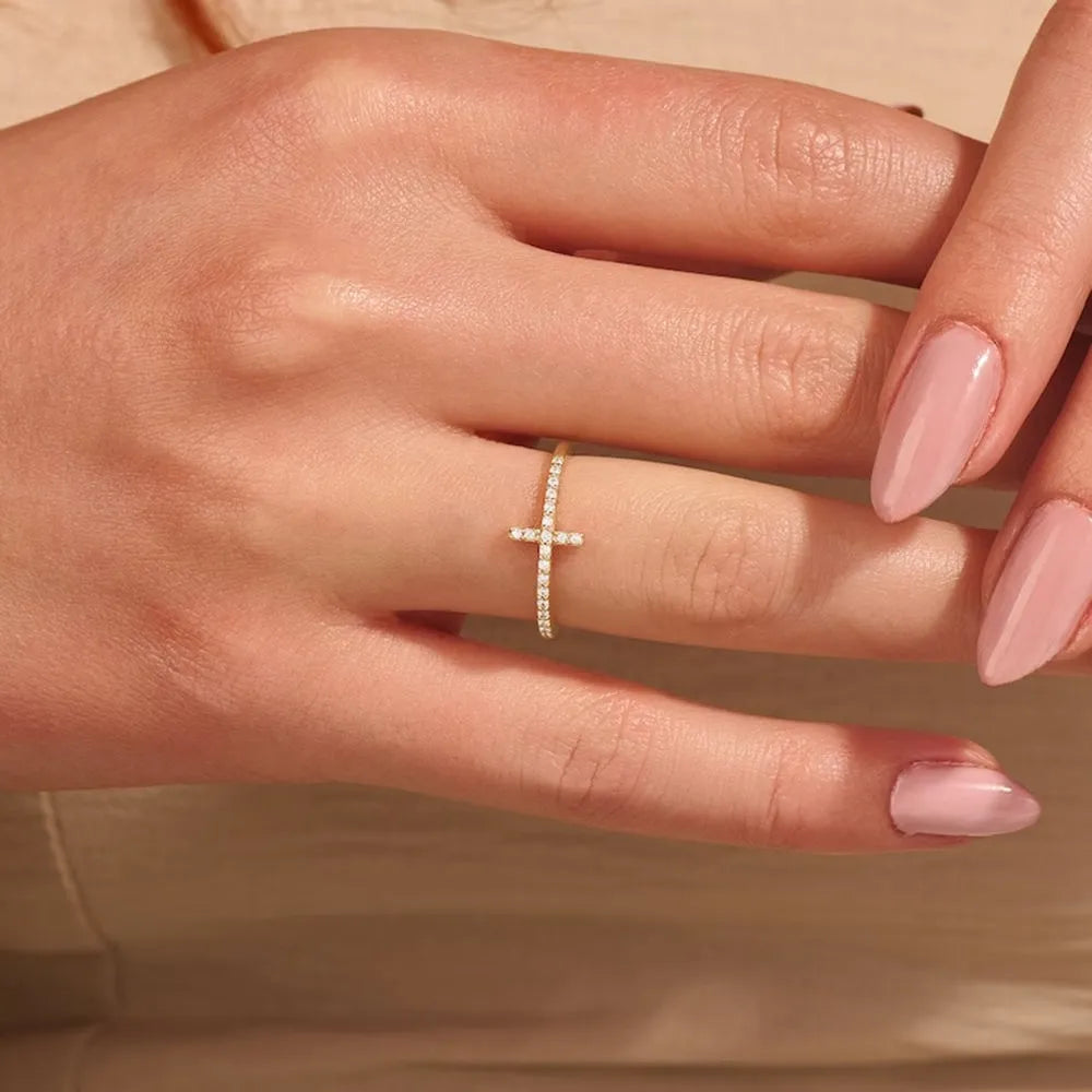 Studio overhead shot of the 14K gold-plated 925 sterling silver cross ring on a clean white background, full band visible with AAAAA cubic zirconia. Hallmarked Loretana piece, hand-finished in Kaunas.