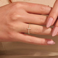 Studio overhead shot of the 14K gold-plated 925 sterling silver cross ring on a clean white background, full band visible with AAAAA cubic zirconia. Hallmarked Loretana piece, hand-finished in Kaunas.