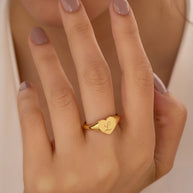 Close-up of the gold heart ring highlighting the open-back adjustable band.