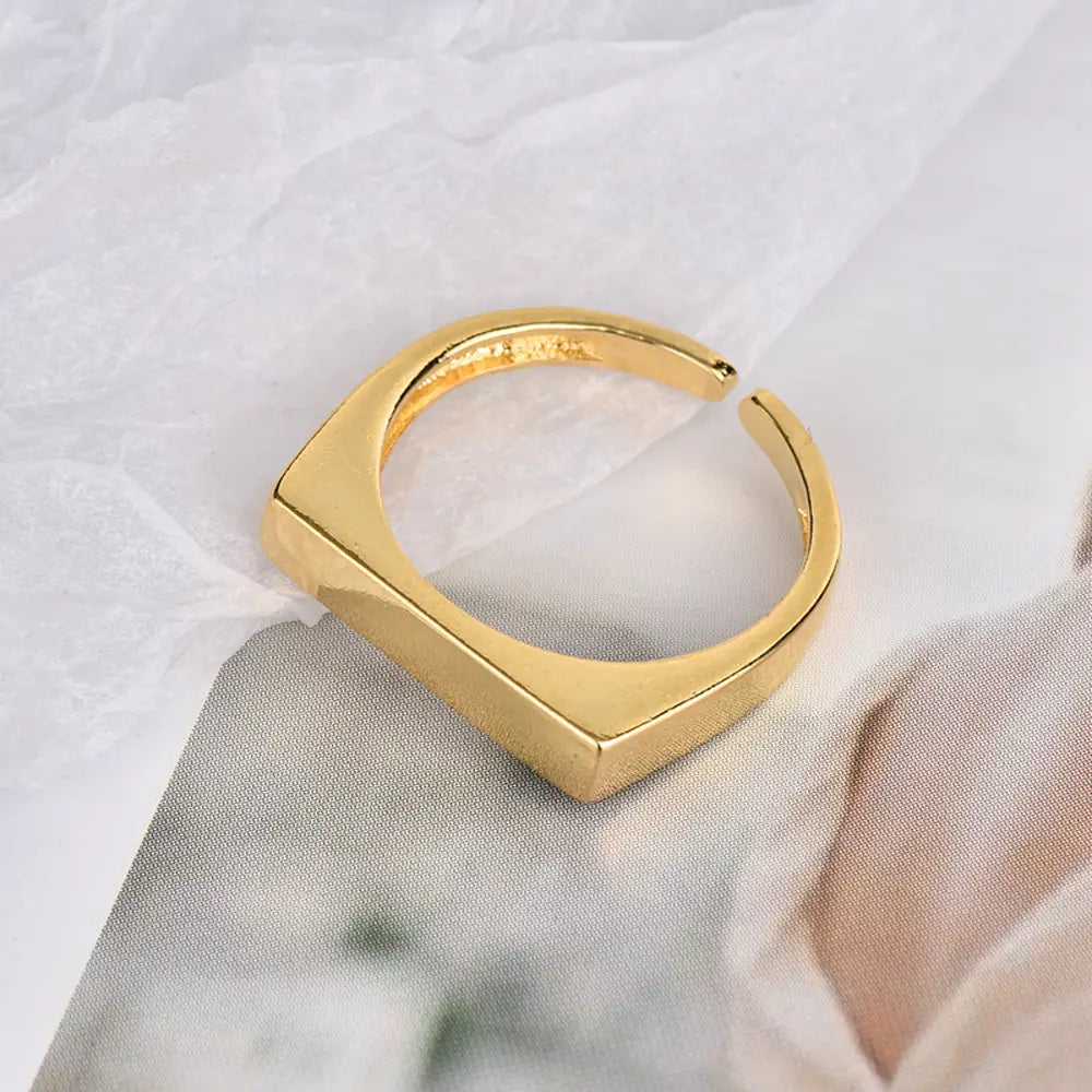 Close-up of a model's hand wearing the personalized 14K gold engravable rectangle ring.