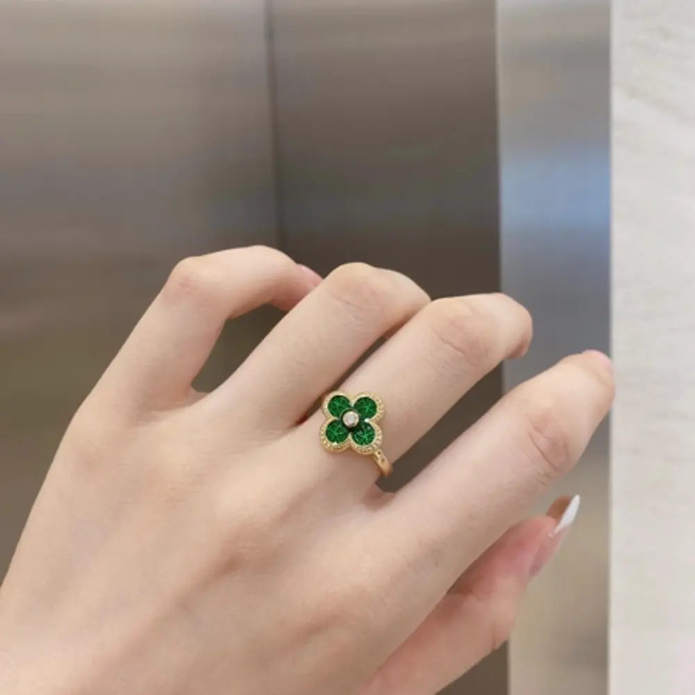 Top view of the Green four leaf clover ring on white, 925 sterling silver with 14K gold plating and brilliant green zirconia stones. Hallmarked Loretana piece, hand-finished in Kaunas.