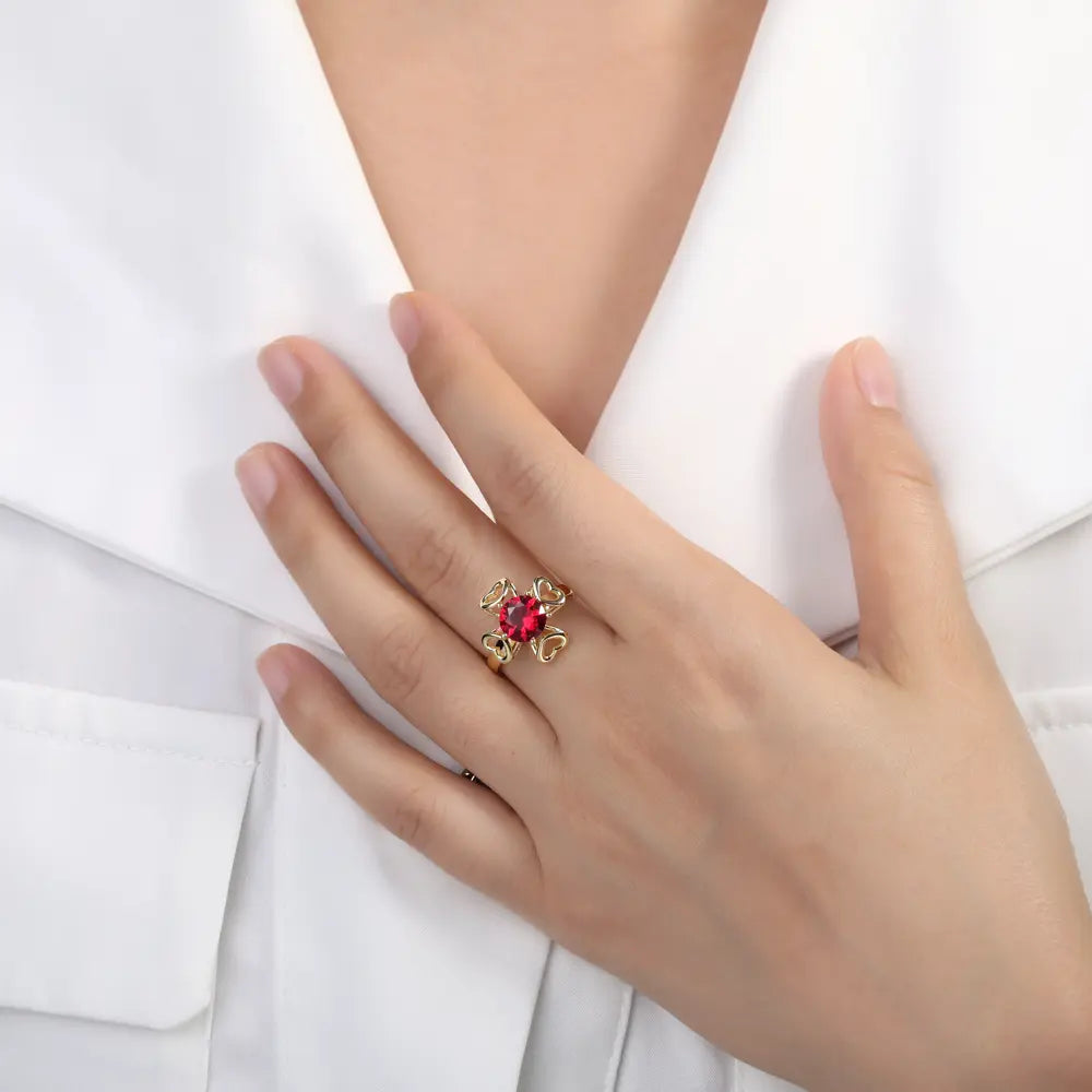 Close-up of a woman's hand wearing the 14K gold interchangeable heart duo ring.