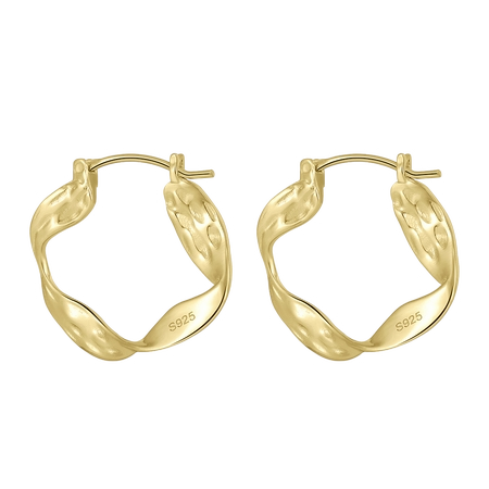 A profile view of a model wearing the sculptural 14K gold-plated irregular wavy hoop earrings.