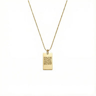 Close up of 14K gold square pendant showing precision laser engraving surface