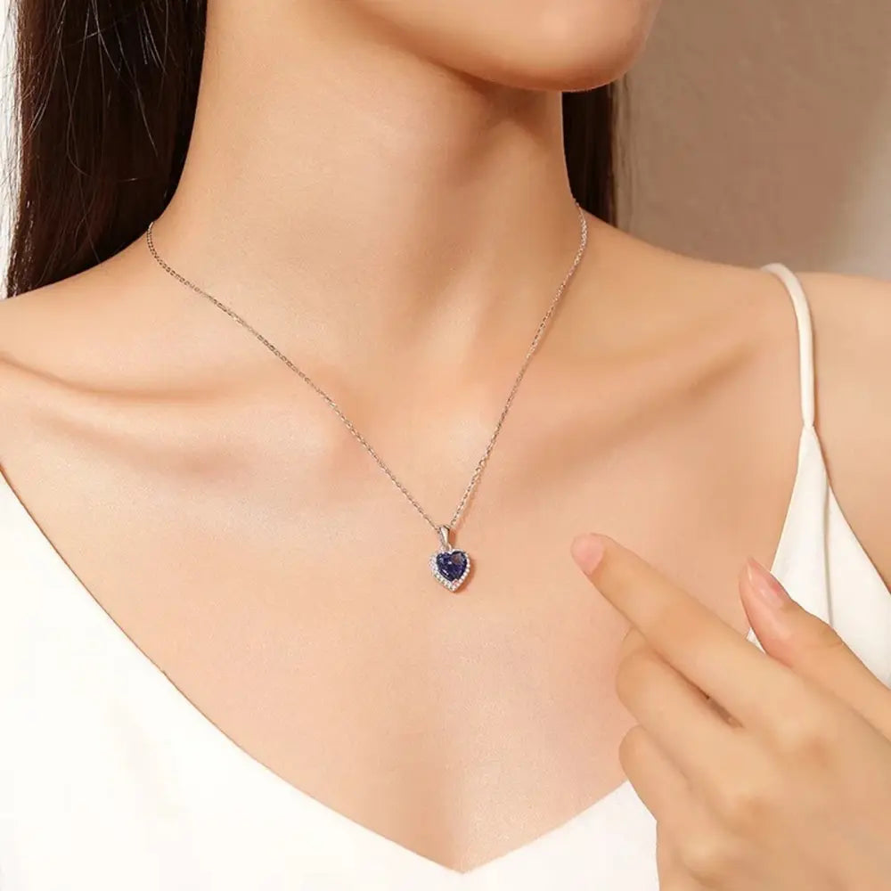 Close up of the 925 Silver Sapphire Heart Necklace showing the precision-cut blue AAAAA zirconia and the mirror-bright rhodium-plated setting.