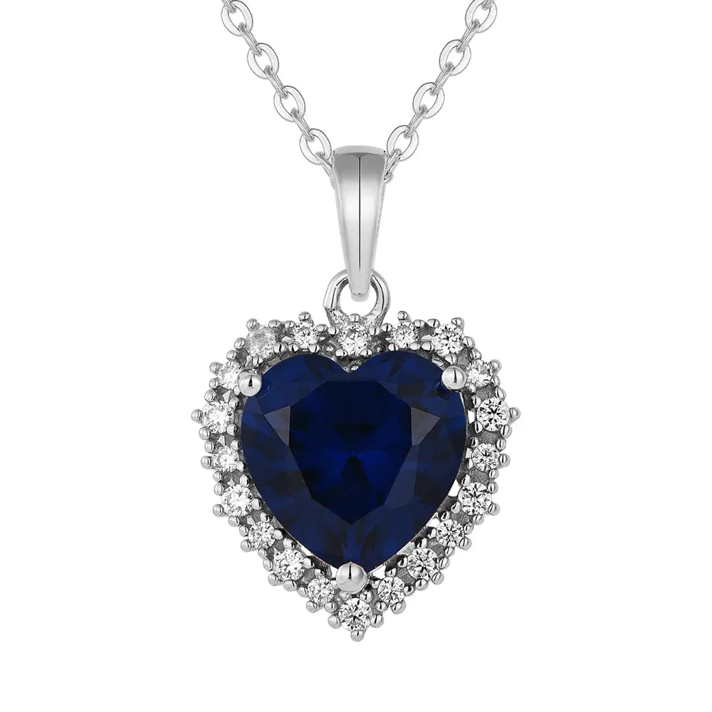 925 Silver Sapphire Heart Necklace in hallmarked 925 sterling silver with a deep blue heart pendant displayed on a pure white background.