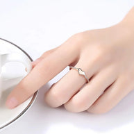 Angled view of the gold heart ring on a hand model, capturing the polished band and heart cut zirconia. Hallmarked Loretana piece, hand-finished in Kaunas.
