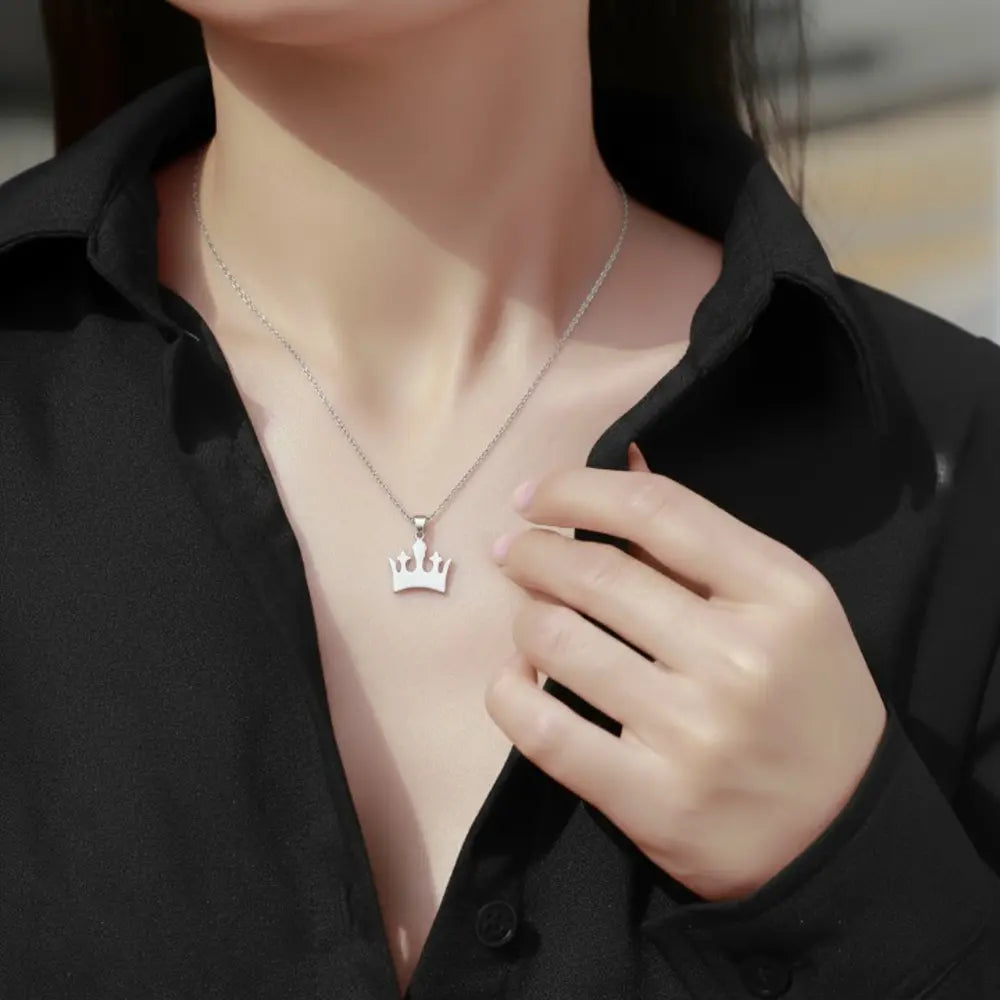 925 silver crown pendant styled in a curated layered neckline
