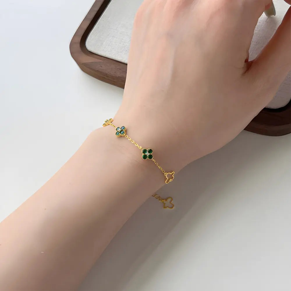 Close up of 14K gold clover bracelet showing precision pavé zirconia setting