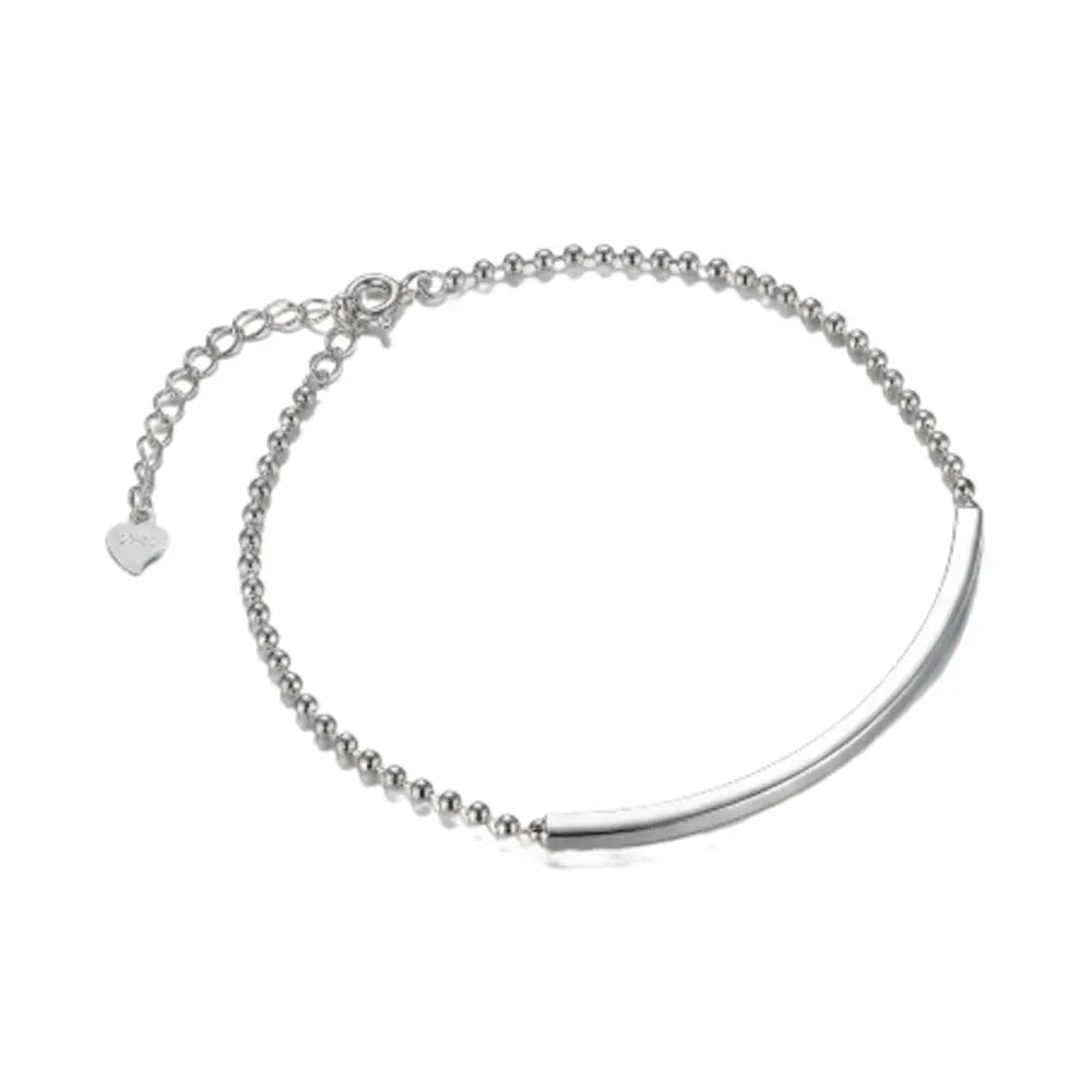 Close up of 925 silver curved bar bracelet showing custom engraving and zirconia setting