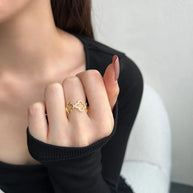 Angled view of the Bloom clover ring with warm 18K gold plating over 925 sterling silver and clover motif. Hallmarked Loretana piece, hand-finished in Kaunas.