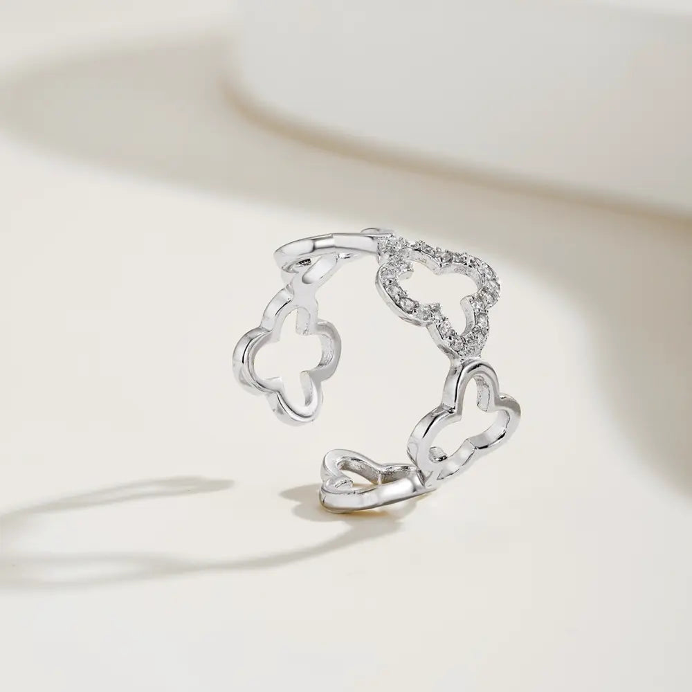 Angled view of the silver Bloom clover ring with mirror bright rhodium plating over 925 sterling silver. Hallmarked Loretana piece, hand-finished in Kaunas.