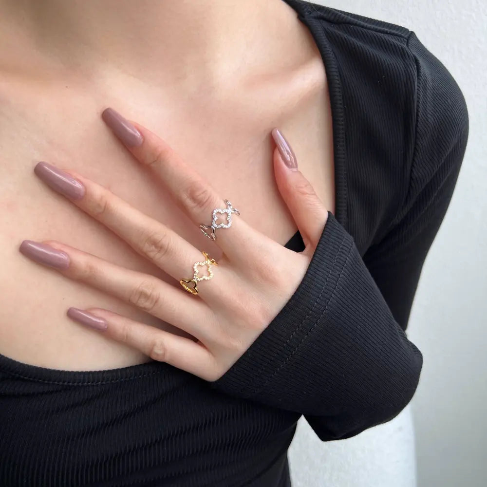 Hand wearing the silver Bloom clover ring in 925 sterling silver with rhodium plating and botanical motif. Hallmarked Loretana piece, hand-finished in Kaunas.
