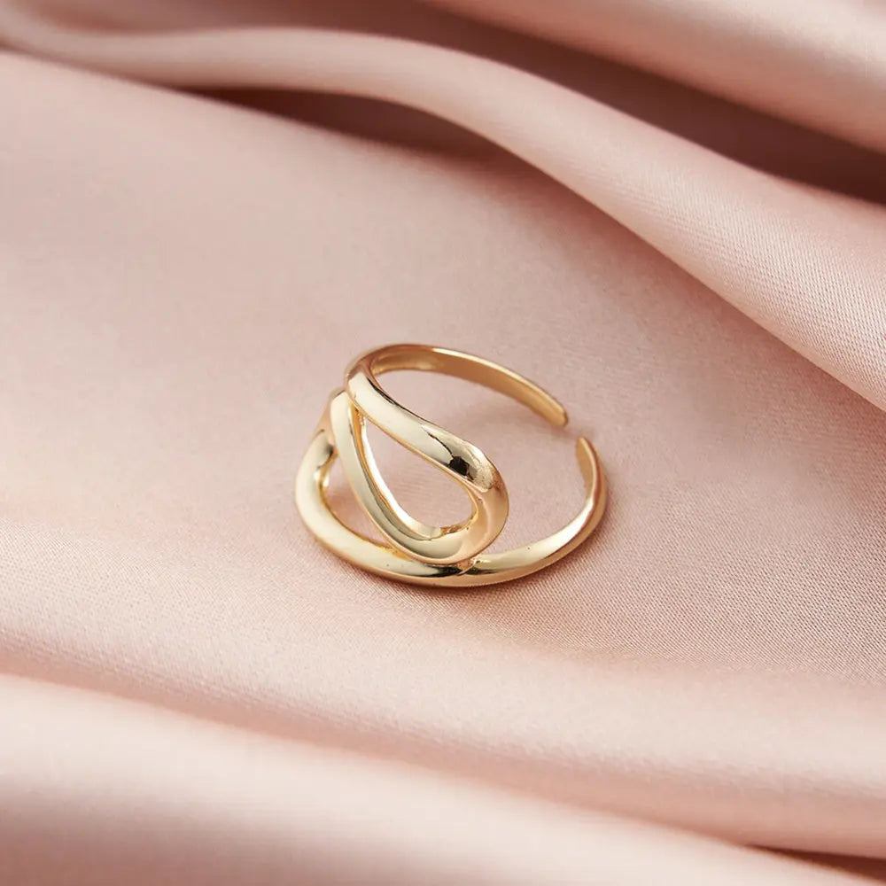 Close-up of a woman's hand wearing the modern 14K gold-plated geometric adjustable ring.
