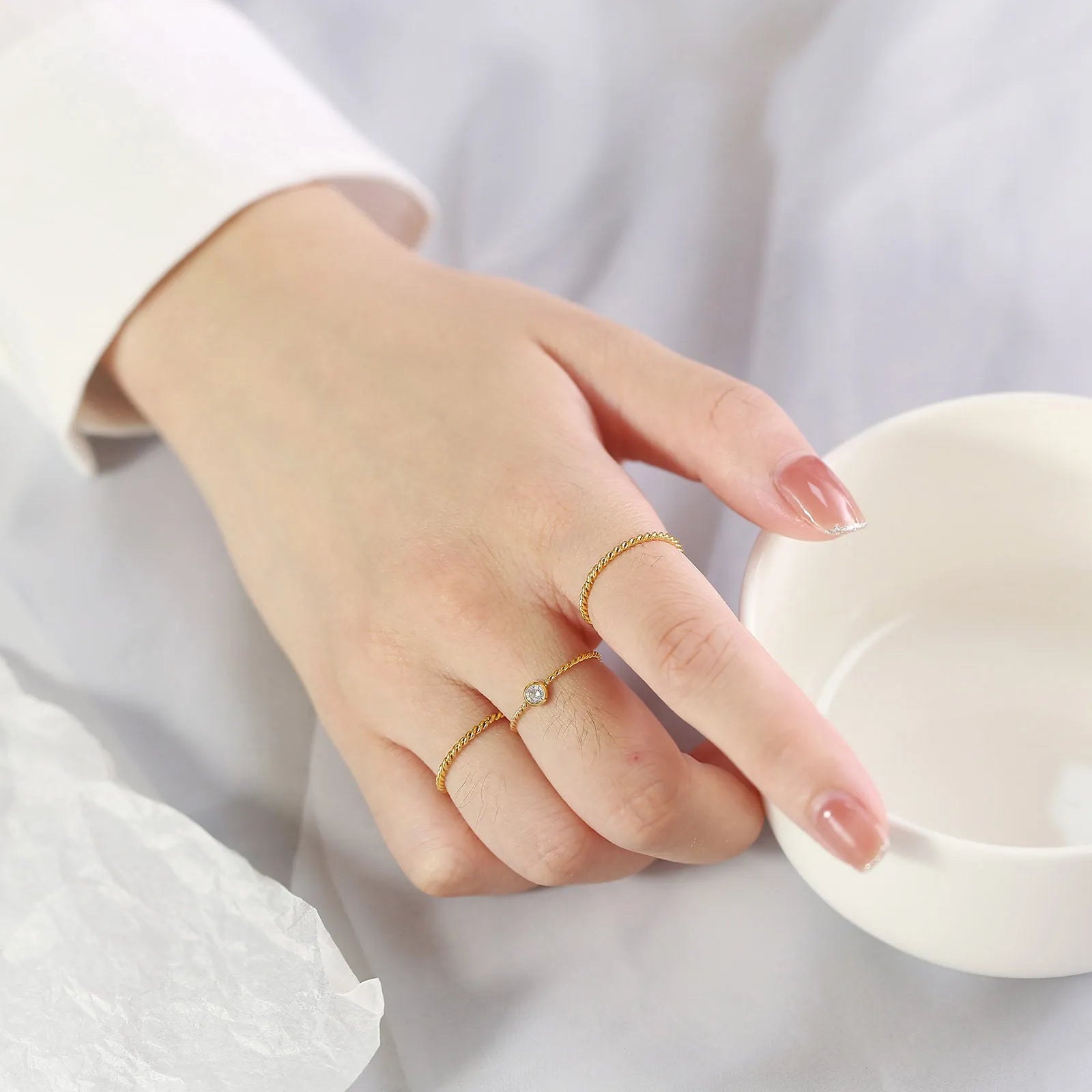 Front view of the 14K gold-plated twisted rope band ring in 925 sterling silver, 2mm stackable design on white background. Hallmarked Loretana piece, hand-finished in Kaunas.