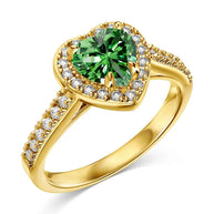 Hand model wearing the 14K gold plated green heart ring, showing the warm band and verdant heart stone. Hallmarked Loretana piece, hand-finished in Kaunas.