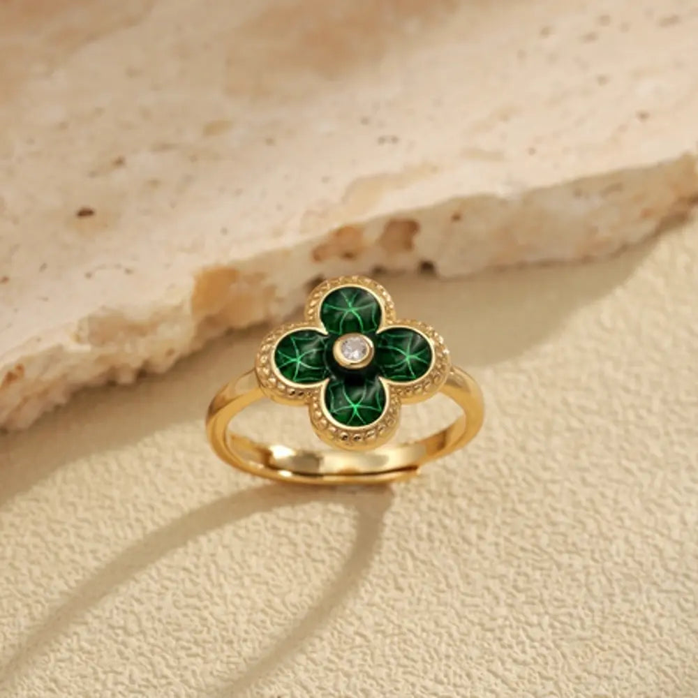 Macro view of the AAAAA green cubic zirconia leaves on the gold plated four leaf clover motif. Hallmarked Loretana piece, hand-finished in Kaunas.