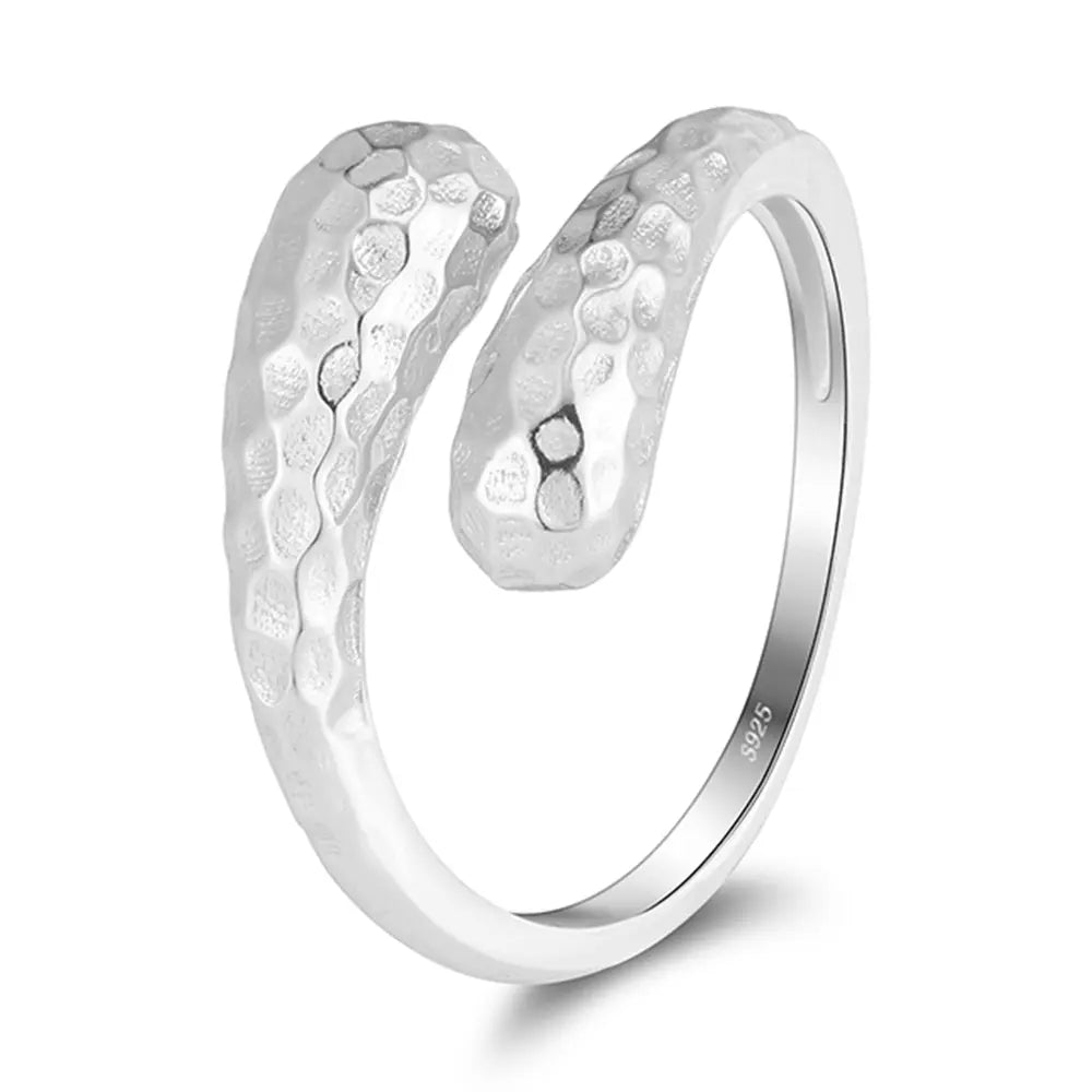 Studio overhead shot of the silver hammered double teardrop adjustable ring set in 925 sterling silver with rhodium plating, both rings laid on a clean white background. Hallmarked Loretana piece, hand-finished in Kaunas.