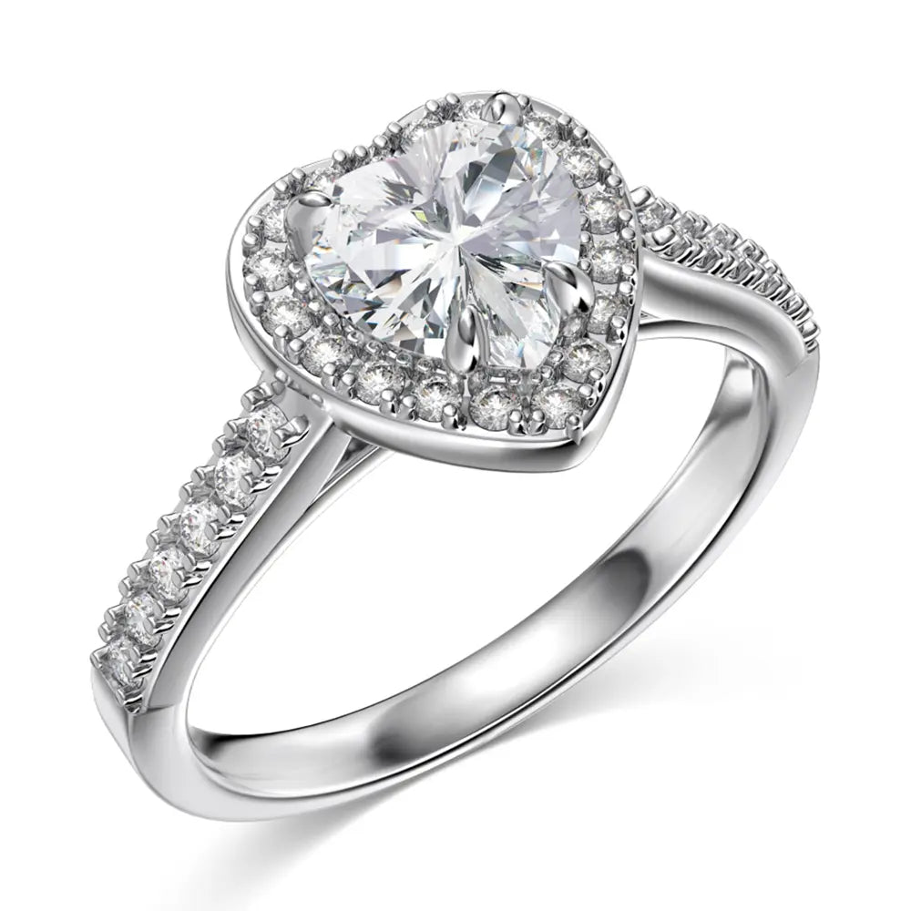 Hand model wearing the white heart zirconia ring in 925 sterling silver with rhodium plating, heart-cut AAAAA white zirconia catching light against the skin. Hallmarked Loretana piece, hand-finished in Kaunas.
